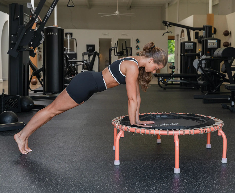 Girl doing a plank on the edge of JumpSport