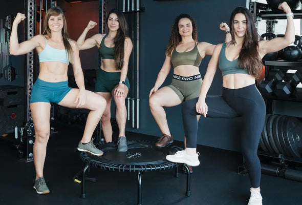 FitJumpUSA Instructors posing with strong arms on the JumpSport trampoline