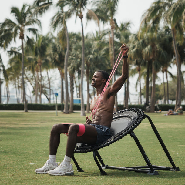 Man using powHER band resistance bands on a JumpSport