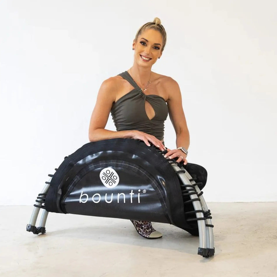 Lisa Raleigh with a folding JumpSport Fitness trampoline, announcing a strategic partnership.